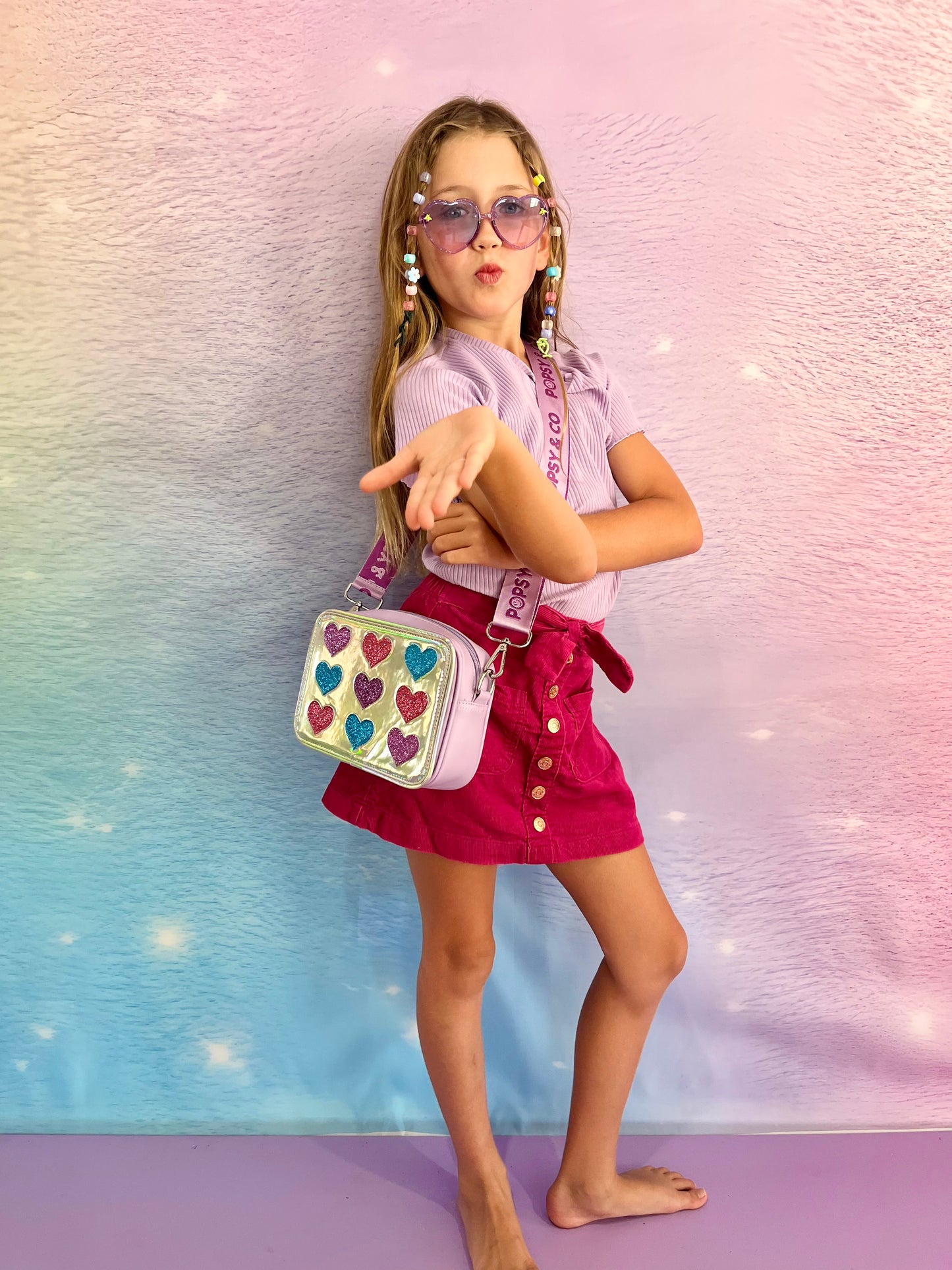 Girl wearing glitter hearts crossbody bag from Popsy and Co