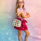 Girl wearing glitter hearts crossbody bag from Popsy and Co