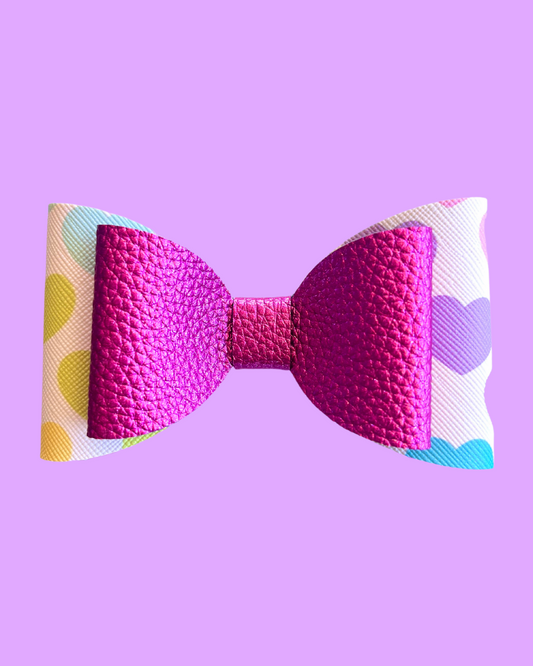 The Sweetheart hair bow. Pink and heart patterned bow.