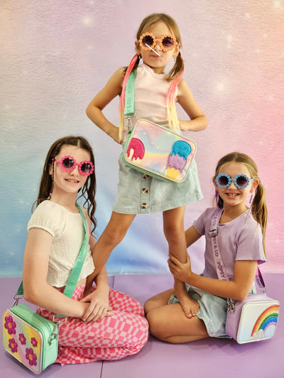 Girls standing in a pyramid wearing kids crossbody bags from Popsy and Co.