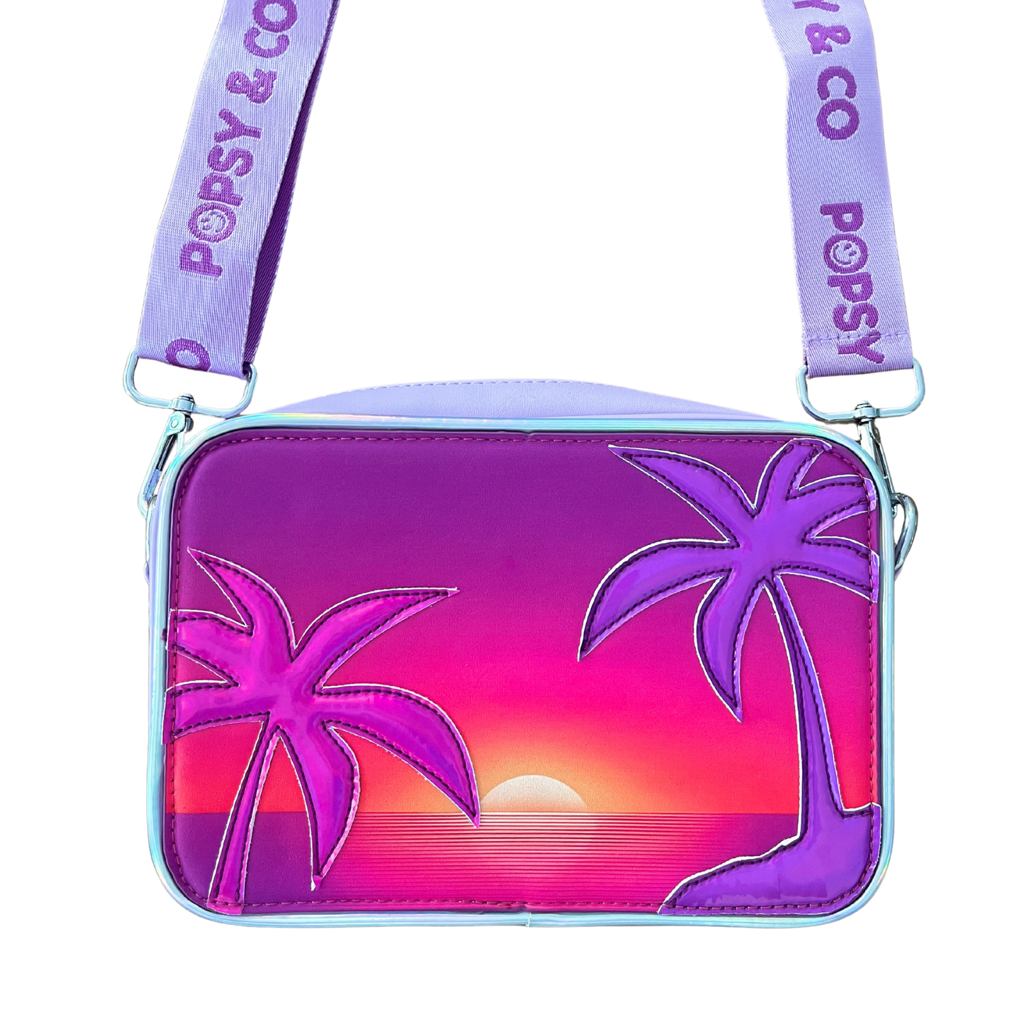 A purple crossbody bag with an interchangeable front cover with a sunset and two palms, one metallic pink and the other metallic purple.