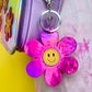 Pink metallic flower smiley keychain. Silver-like clip