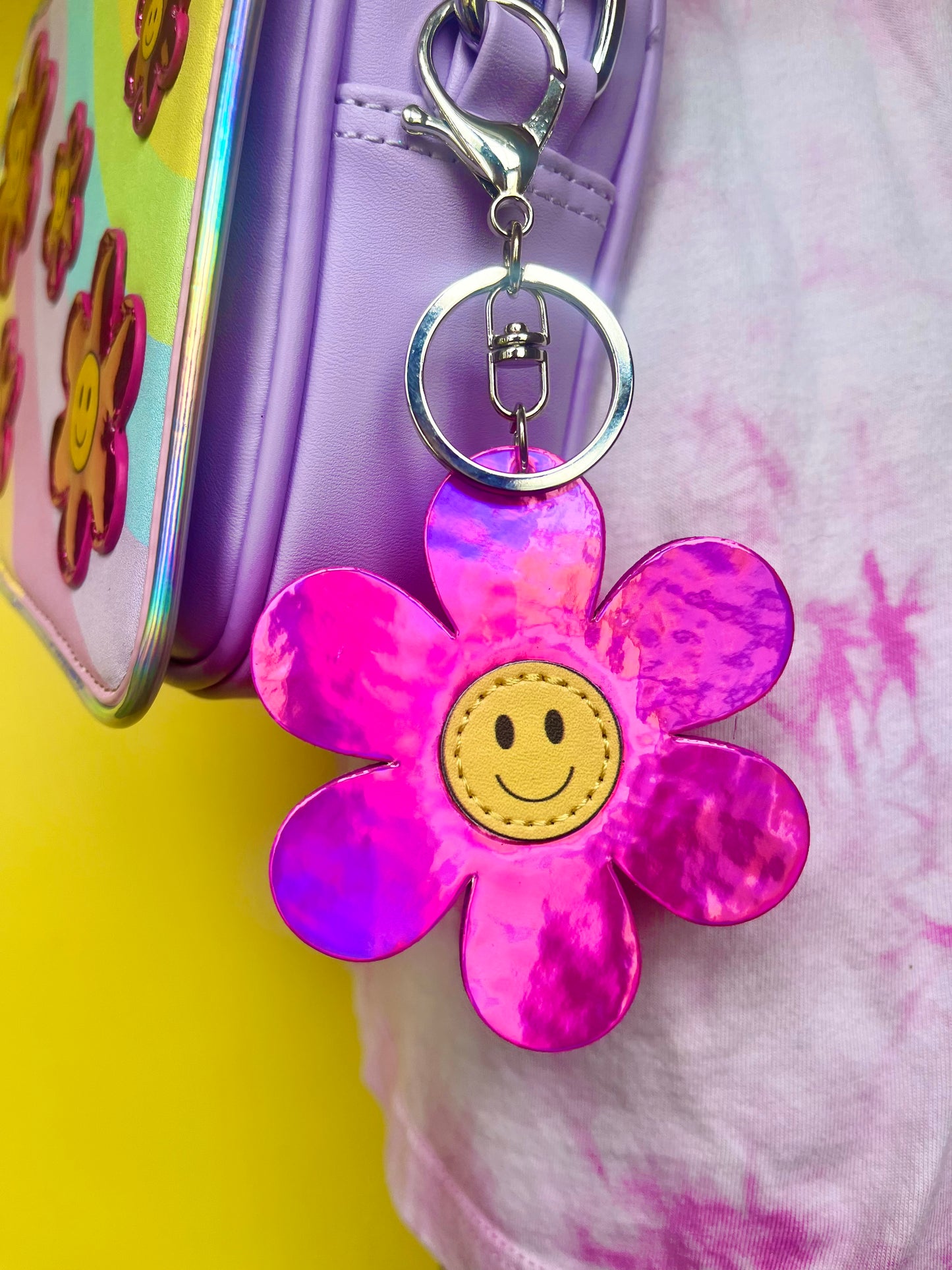 Pink metallic flower smiley keychain. Silver-like clip