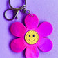 Pink smiley flower bag charm from Popsy & Co. It has a silver-like clasp.
